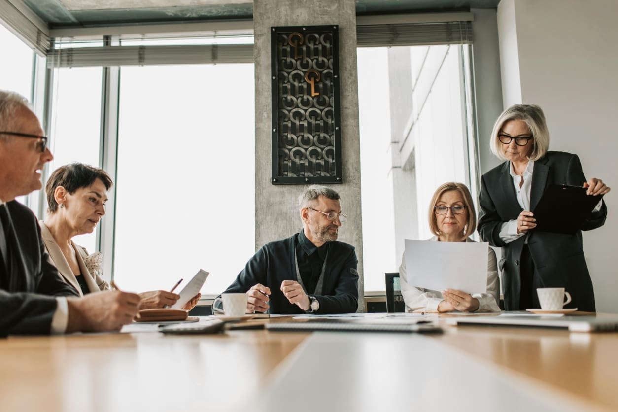 A group of professionals collaborating in a modern office meeting.
